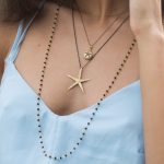 girl wearing big starfish necklace gold plated