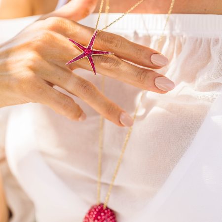 woman wears sterling silver gold plated starfish necklace with red enamel