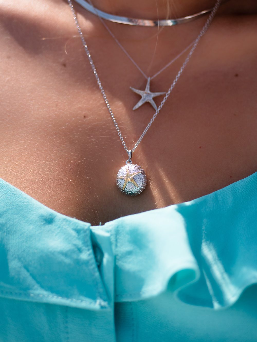 girl wearing sterling silver sea urchin necklace