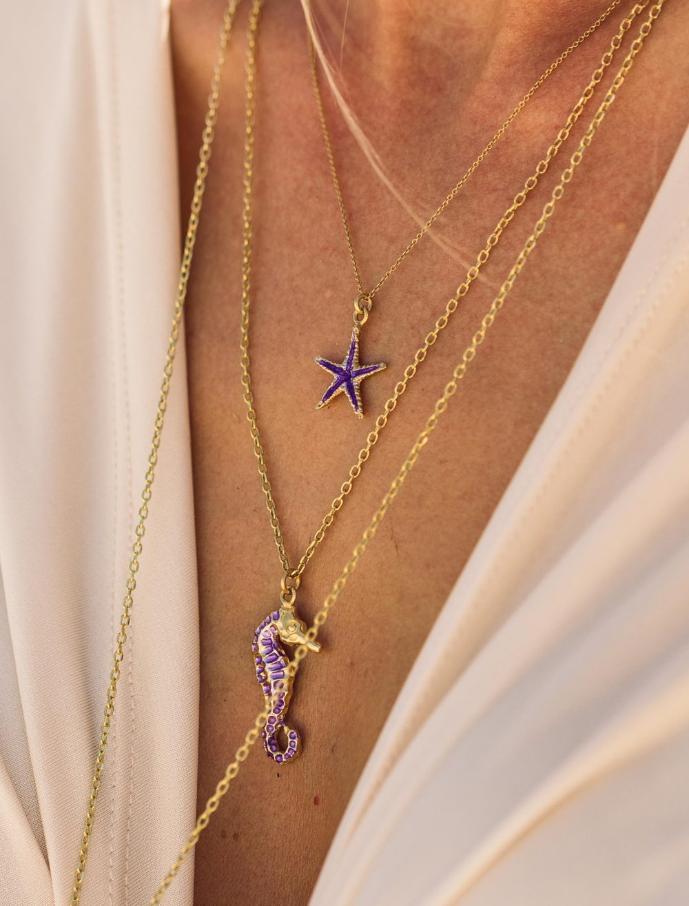 girl wearing sterling silver starfish necklace with purple enamel