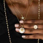 Girl wearing sea urchin necklace with white enamel