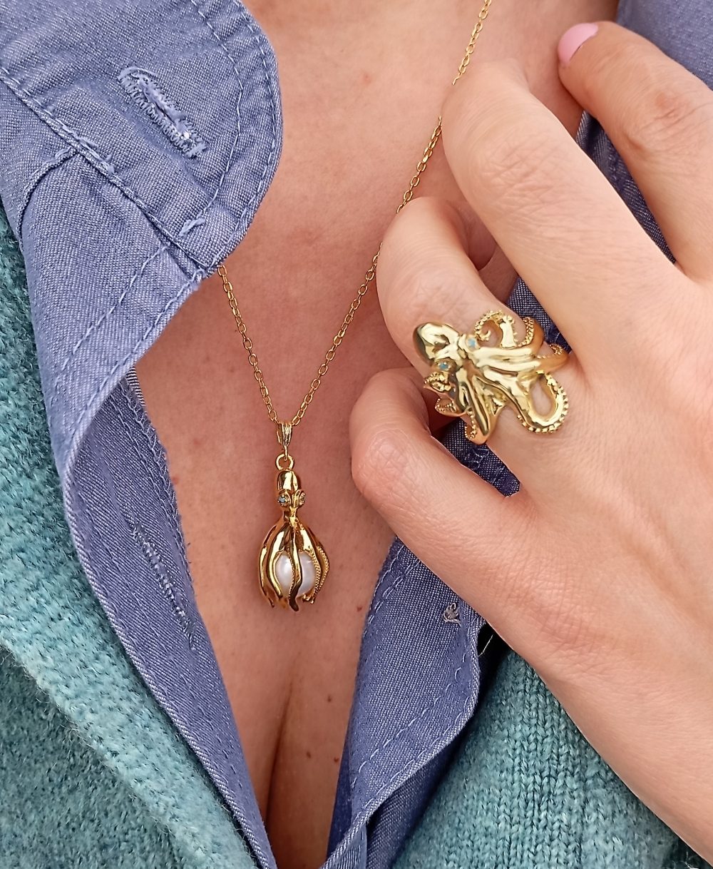 Woman wearing statement octopus ring and necklace gold plated